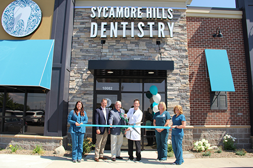 Nicholas Rorick, D. D. S.. cuts the ribbon at the opening ceremony for Sycamore Hills Dentistry.