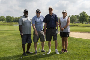 four golfers posing for a photo at the greater golf open event