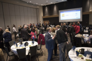 a room full of people networking before a legislative preview event