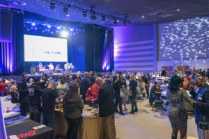 the clyde theatre full of people socializing at the greater fort wayne inc. holiday night event