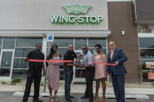 the owners of Wing Stop cut the ribbon at their new location in Fort Wayne