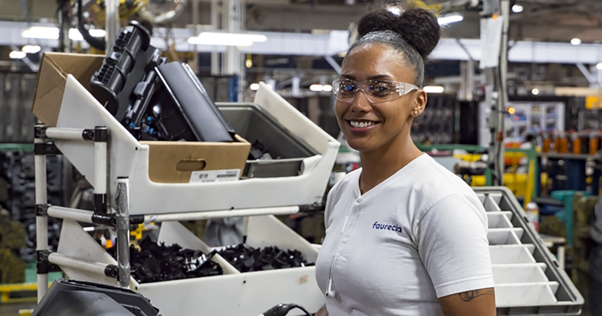 woman working at factory with equipment in background