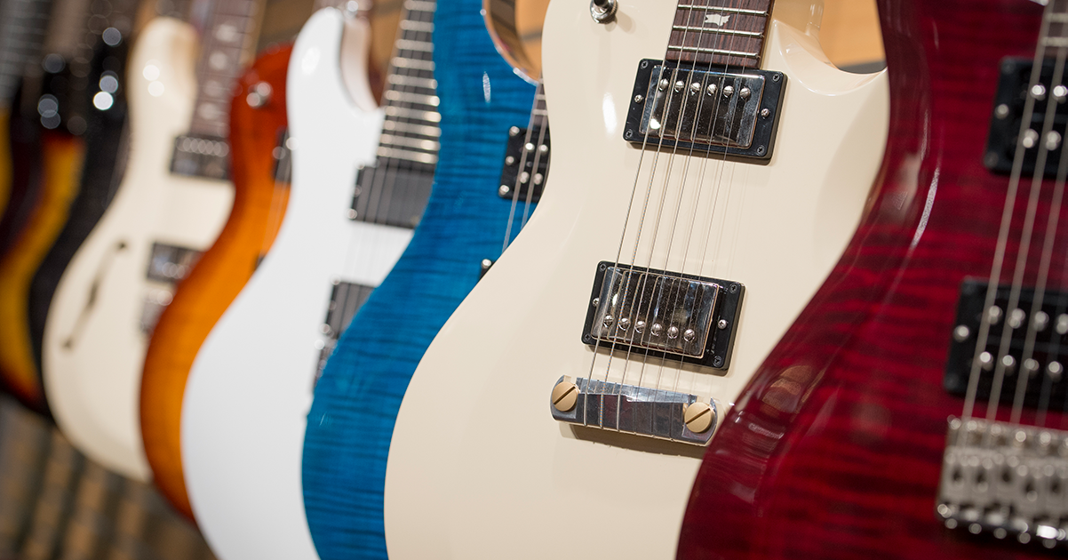 row of guitars on display in showroom