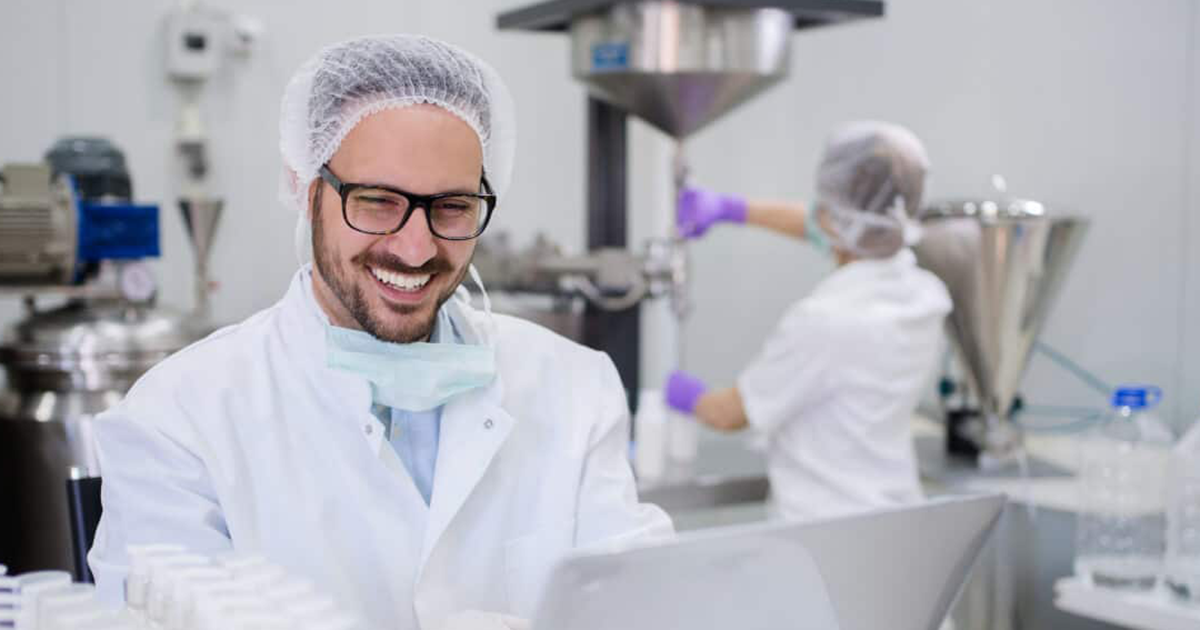 man in lab working with a computer