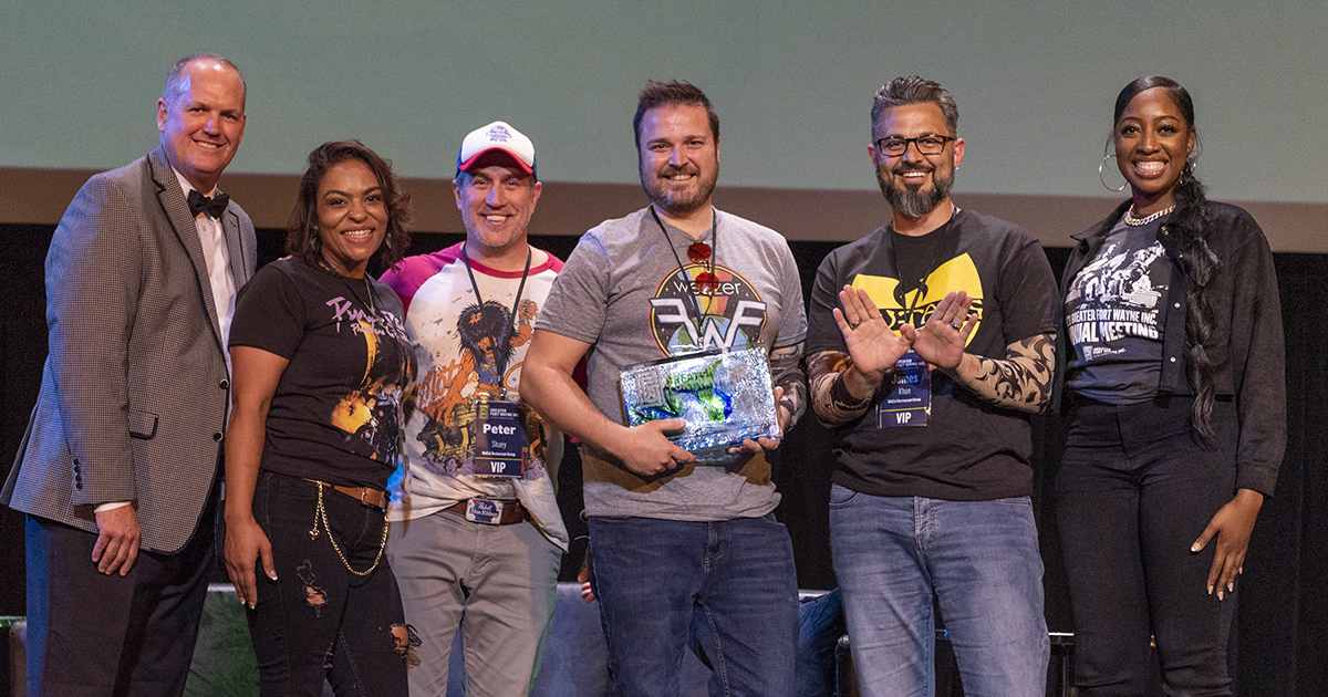 Members of the Hoppy Gnome staff accept the 2022 Small Business of the Year Award on stage at the GFW Inc. Annual Meeting