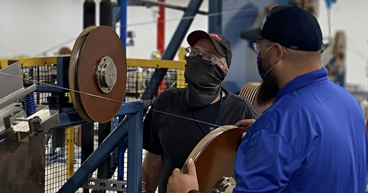 two men working at fort wayne metals