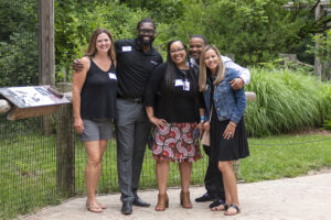 a group of people poses for a photo while taking a tour of the fort wayne children's zoo