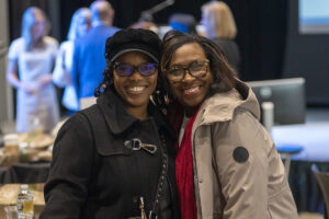 two people pose for a photo at a greater fort wayne inc women's network event