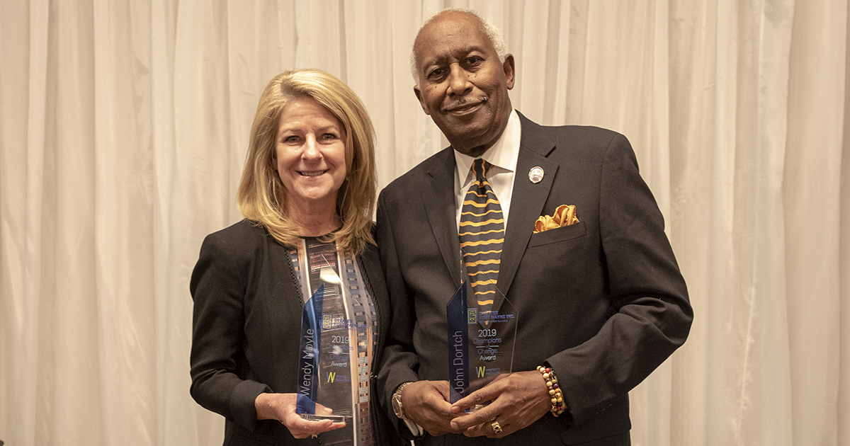 Wendy Moyle and John Dortch pose with their Champions of Change awards