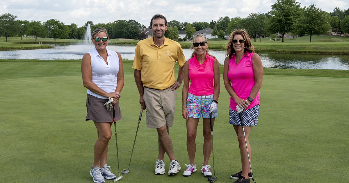 A team of four golfers poses for a photo at the Greater Golf Open