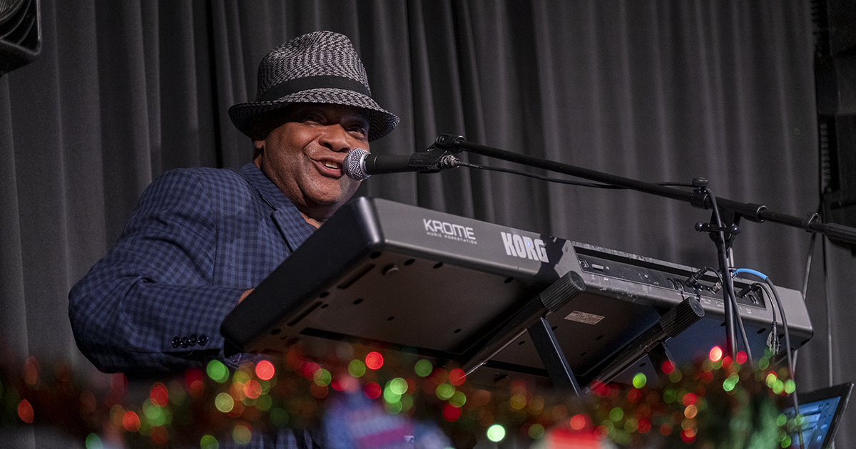 A pianist plays a song at the GFW Inc. Holiday Night event