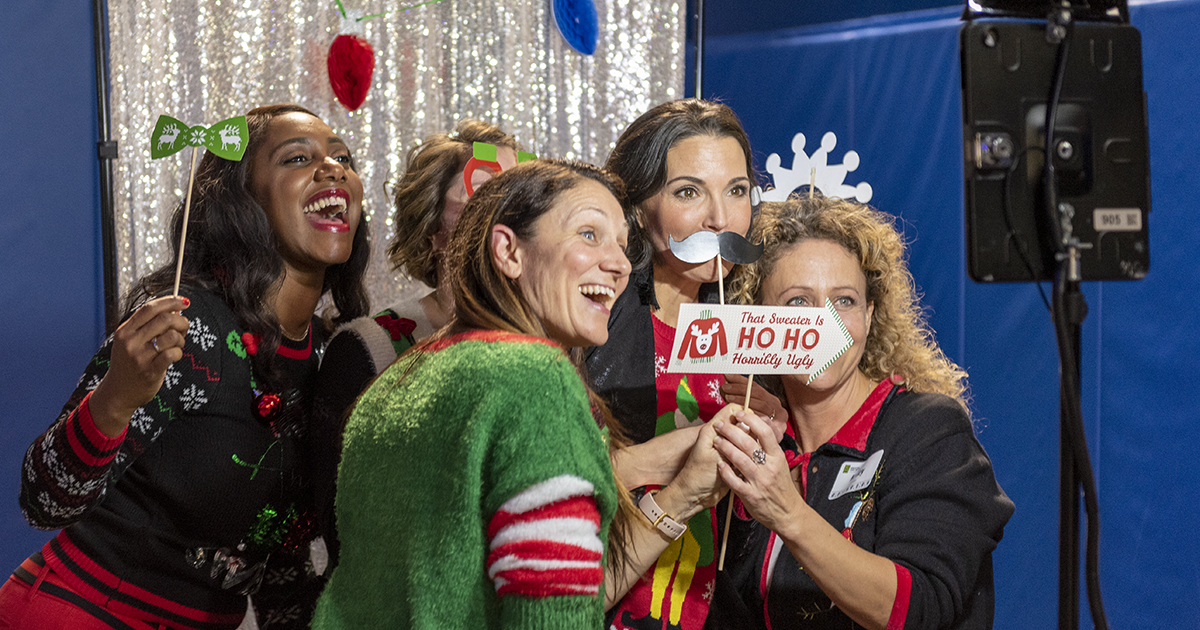 Five people pose for a photo at the GFW Inc. Holiday Night event