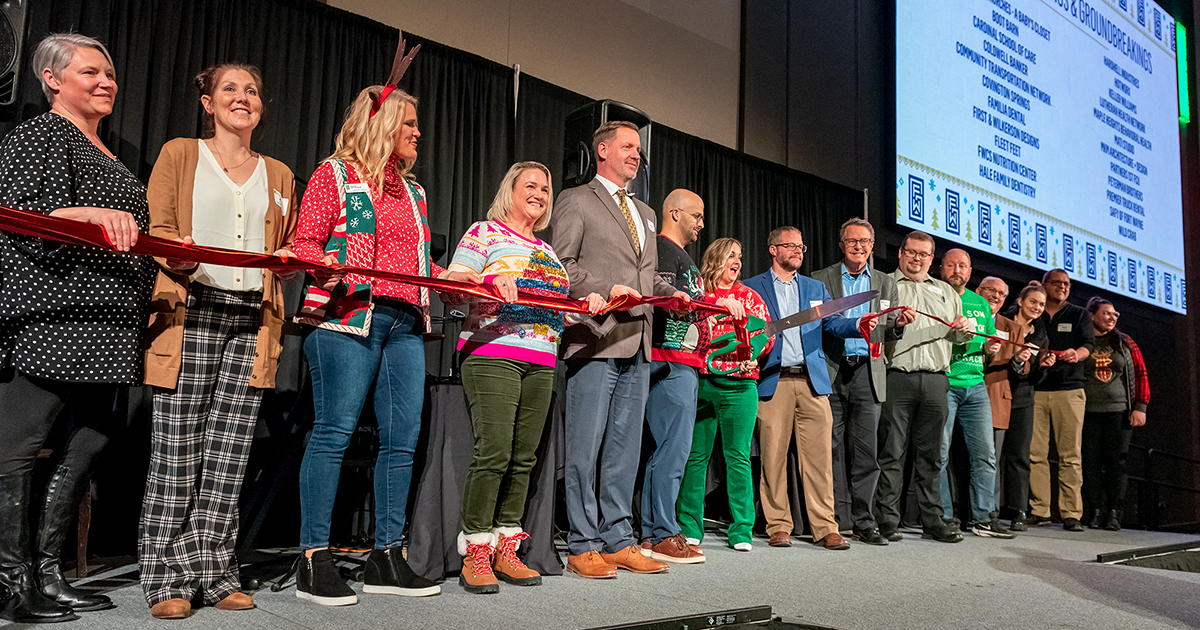 Business leaders pose for a year-end ribbon-cutting ceremony at the GFW Inc. Holiday Night event