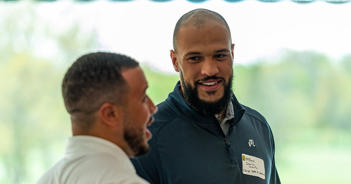 Two people chat at a "Meet Me at 5:05" networking event