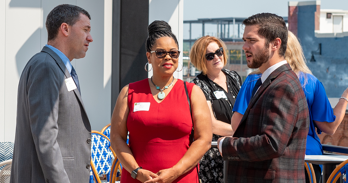 Three people chat before an Allen County Leaders Luncheon