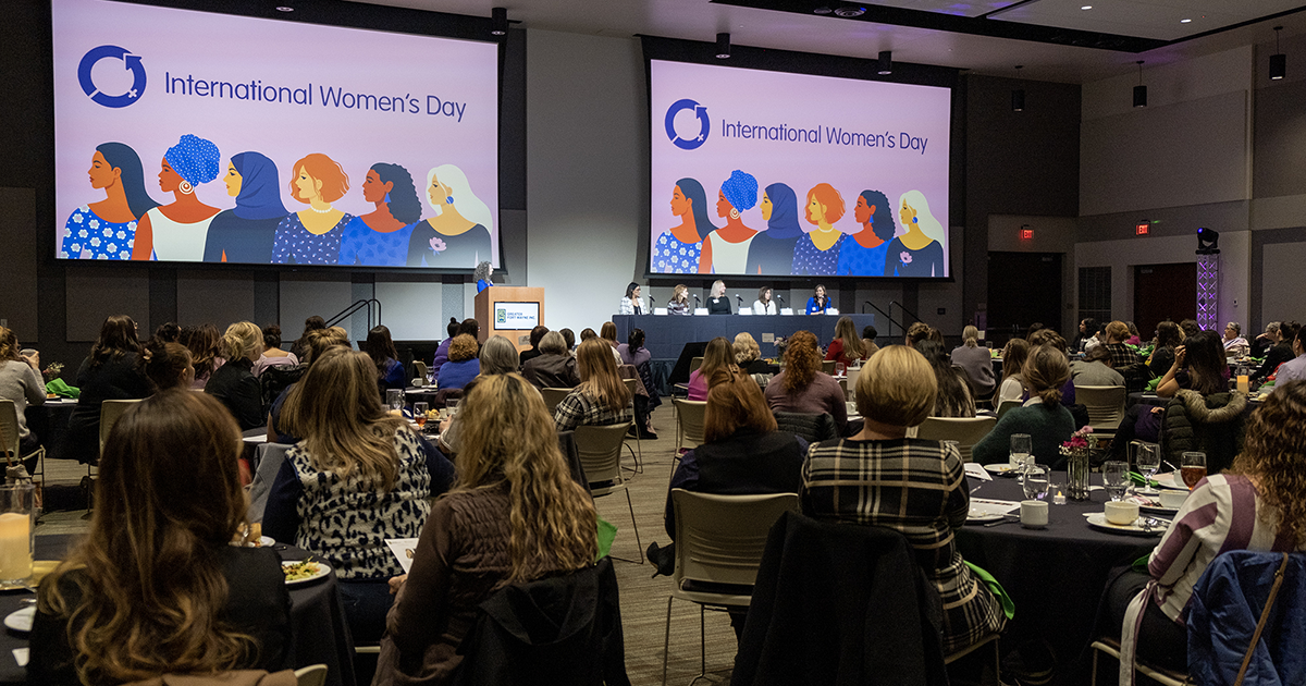 A room full of people listens to a panel discussion at a GFW Inc. Women's Network event