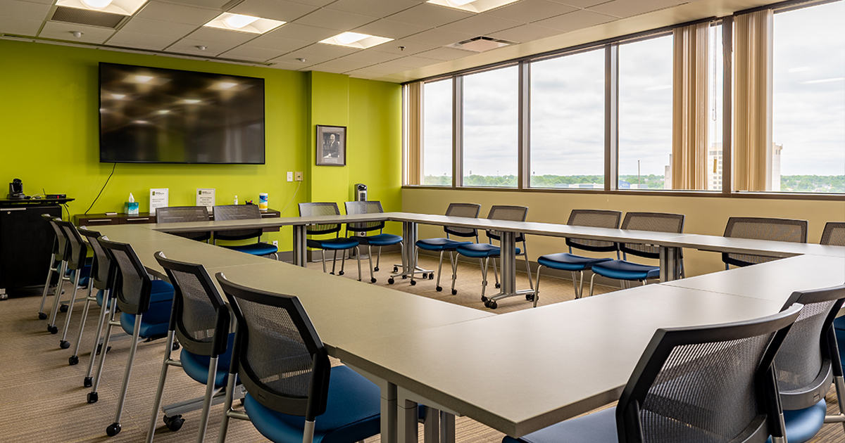 Photo of tables, chairs, and TV in the Doermer Central conference room