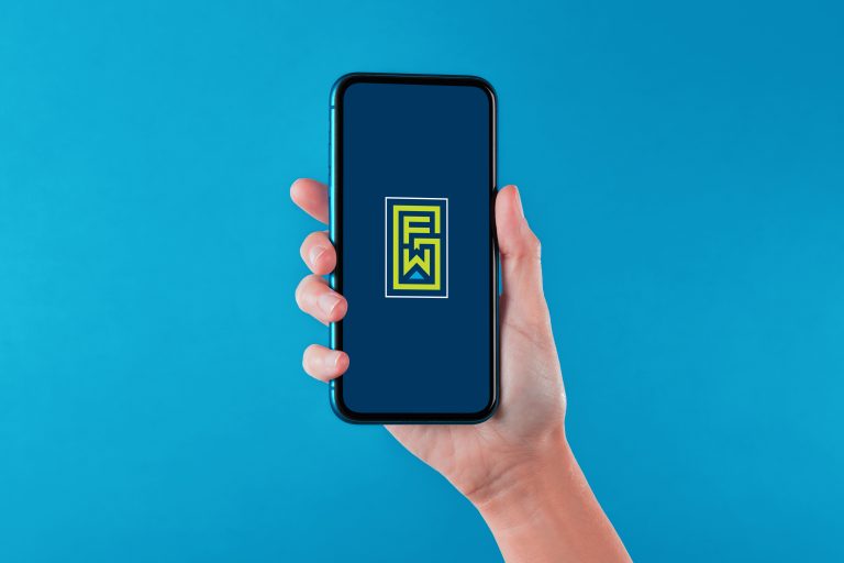 hand holding phone with Greater Fort Wayne Inc. logo