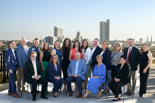 GFW Inc. staff in front of the Fort Wayne skyline