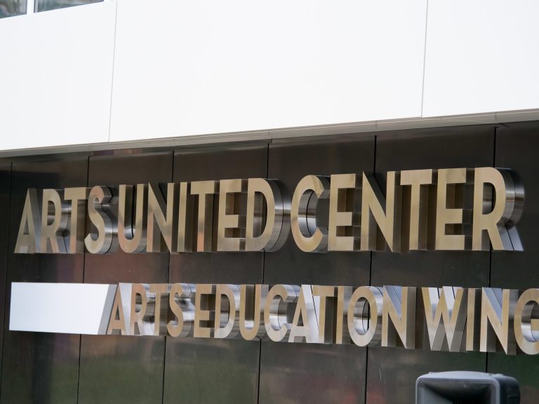 Picture of the Arts United Center words on the side of the building