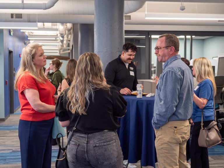 Professionals attend a leads group social