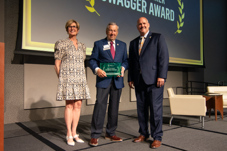 Don Steininger, Maclyn Parker Swagger award winner standing on stage.