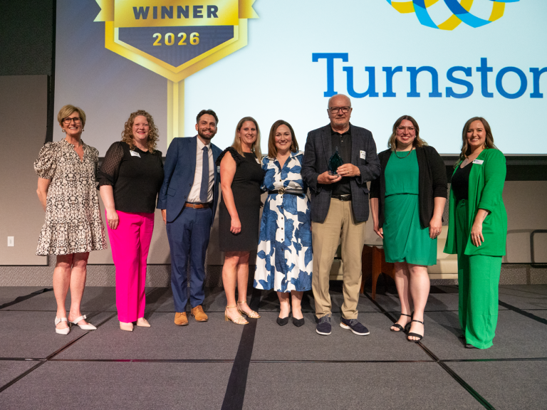 Turnstone non-profit award winners standing on stage.